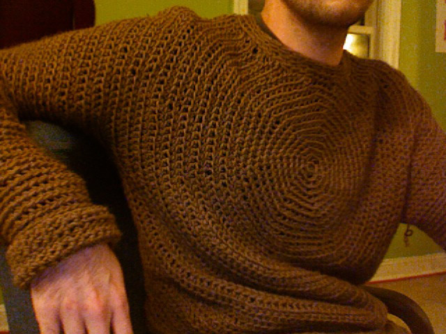 A crochet sweater generated with this application. The crochet pattern radiates out from the center of the chest, seamlessly down the arms and around to the back.
