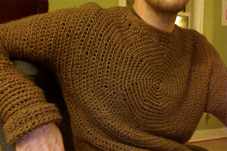 A crochet sweater generated with this application. The crochet pattern radiates out from the center of the chest, seamlessly down the arms and around to the back.